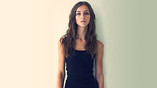 woman with brown hair wearing black sleeveless top